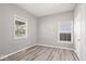 Simple bedroom with gray walls, wood-look floors, and a window at 1709 Hoyt Ave, Indianapolis, IN 46203