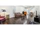 Living room features hardwood floors, a plaid couch and an orange recliner at 2028 Hoyt Ave, Indianapolis, IN 46203