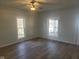 Living room with hardwood floors and two windows at 325 E Church St, Paragon, IN 46166