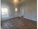 Spacious living room with hardwood floors and an interior door at 325 E Church St, Paragon, IN 46166