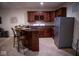 Basement wet bar with dark wood cabinets and granite countertops at 7610 Monte Carlo Way, Indianapolis, IN 46278
