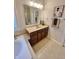 Bathroom with vanity, large mirror, and beige tile flooring at 7610 Monte Carlo Way, Indianapolis, IN 46278