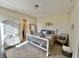 Spacious bedroom with a large bed, dresser, and sitting area at 7610 Monte Carlo Way, Indianapolis, IN 46278
