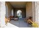 Relaxing covered patio with wicker furniture, perfect for outdoor entertaining at 7610 Monte Carlo Way, Indianapolis, IN 46278