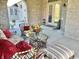 Relaxing covered patio furnished with wicker seating and a glass-top table at 7610 Monte Carlo Way, Indianapolis, IN 46278