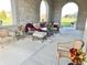 Spacious covered patio with wicker furniture and fall decor at 7610 Monte Carlo Way, Indianapolis, IN 46278