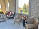 Relaxing covered patio with wicker seating and fall decor at 7610 Monte Carlo Way, Indianapolis, IN 46278