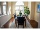 Elegant dining room featuring hardwood floors, a large window, and a formal dining table at 7610 Monte Carlo Way, Indianapolis, IN 46278