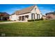 Brick home with a 3-car garage and well-manicured lawn at 7610 Monte Carlo Way, Indianapolis, IN 46278