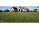 Brick house with a large front yard, showcasing curb appeal at 7610 Monte Carlo Way, Indianapolis, IN 46278