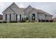 Stunning brick house with dark shutters and professionally landscaped yard at 7610 Monte Carlo Way, Indianapolis, IN 46278
