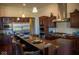 Kitchen with granite island, stainless steel appliances, and dark wood cabinetry at 7610 Monte Carlo Way, Indianapolis, IN 46278