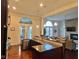 Kitchen features a large island with seating, stainless steel appliances, and access to backyard at 7610 Monte Carlo Way, Indianapolis, IN 46278