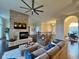Open living room with a stone fireplace, hardwood floors, and comfortable seating at 7610 Monte Carlo Way, Indianapolis, IN 46278