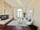 Elegant living room with hardwood floors, a stone fireplace, and chic furnishings at 7610 Monte Carlo Way, Indianapolis, IN 46278