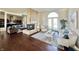 Bright living room with hardwood floors, a stone fireplace, and comfortable seating at 7610 Monte Carlo Way, Indianapolis, IN 46278