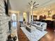 Living room with a stone fireplace, hardwood floors, and access to kitchen at 7610 Monte Carlo Way, Indianapolis, IN 46278