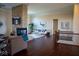 Open living area with a stone fireplace, hardwood floors, and a view to the kitchen at 7610 Monte Carlo Way, Indianapolis, IN 46278