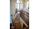 Open staircase with wood railings and carpeted steps at 7610 Monte Carlo Way, Indianapolis, IN 46278