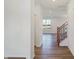 Bright hallway with hardwood floors and staircase at 5856 Fair Oak Cir, Brownsburg, IN 46112