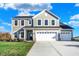 Two-story house with taupe siding, white trim, and a three-car garage at 5856 Fair Oak Cir, Brownsburg, IN 46112
