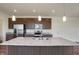Kitchen island with granite countertop and stainless steel sink at 5856 Fair Oak Cir, Brownsburg, IN 46112