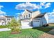 Two-story house with taupe siding, white trim, and a three-car garage at 5856 Fair Oak Cir, Brownsburg, IN 46112