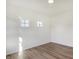 Simple bedroom with hardwood floors and two windows at 5856 Fair Oak Cir, Brownsburg, IN 46112