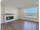 Living room with hardwood floors, fireplace, and large window at 5856 Fair Oak Cir, Brownsburg, IN 46112