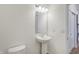 Simple bathroom with pedestal sink and a large mirror at 5856 Fair Oak Cir, Brownsburg, IN 46112