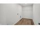 Laundry room with wood-look flooring and overhead shelving at 5856 Fair Oak Cir, Brownsburg, IN 46112