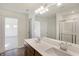 Double vanity bathroom with wood cabinets and a frameless shower at 5856 Fair Oak Cir, Brownsburg, IN 46112
