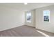 Bright bedroom with neutral walls, carpet, and two windows at 5856 Fair Oak Cir, Brownsburg, IN 46112
