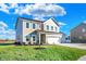 Two-story house with taupe siding, white trim, and a three-car garage at 5856 Fair Oak Cir, Brownsburg, IN 46112