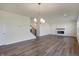 Bright living room features hardwood floors, fireplace, and a chandelier at 5856 Fair Oak Cir, Brownsburg, IN 46112