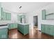 Modern kitchen with island and green cabinets at 631 Cottage Ave, Indianapolis, IN 46203