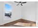 Simple bedroom with hardwood floors, ceiling fan, and large window at 631 Cottage Ave, Indianapolis, IN 46203