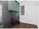 Laundry room with dark gray shiplap and green cabinets at 631 Cottage Ave, Indianapolis, IN 46203