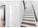 White and wood staircase with dark railing at 631 Cottage Ave, Indianapolis, IN 46203