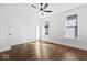 Sunny bedroom featuring hardwood floors, ceiling fan, and white walls at 631 Cottage Ave, Indianapolis, IN 46203