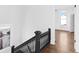 Upper hallway with dark railing and hardwood floors at 631 Cottage Ave, Indianapolis, IN 46203