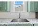 Kitchen sink with granite countertop and subway tile backsplash at 631 Cottage Ave, Indianapolis, IN 46203