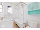 Bathroom with clawfoot tub and teal cabinet at 631 Cottage Ave, Indianapolis, IN 46203