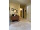 Long hallway with Gathering photos and carpet at 7978 Lawrence Woods Ct, Indianapolis, IN 46236