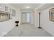 Basement hallway with carpeted floor and artwork at 9545 Bay Vista W Dr, Indianapolis, IN 46250