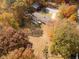 Ranch home surrounded by colorful autumn trees and expansive lawn at 104 Mohawk Ln, West Lafayette, IN 47906