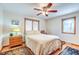 Bright bedroom with a comfortable bed, hardwood floors, and ceiling fan at 104 Mohawk Ln, West Lafayette, IN 47906