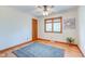 Spacious bedroom with hardwood floors, large window, and ceiling fan at 104 Mohawk Ln, West Lafayette, IN 47906