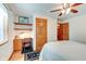 Charming bedroom with a built-in desk, hardwood floors, and ceiling fan at 104 Mohawk Ln, West Lafayette, IN 47906