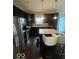 Kitchen with dark cabinets, stainless steel appliances, and an island at 9130 Tansel Crk Dr, Indianapolis, IN 46234